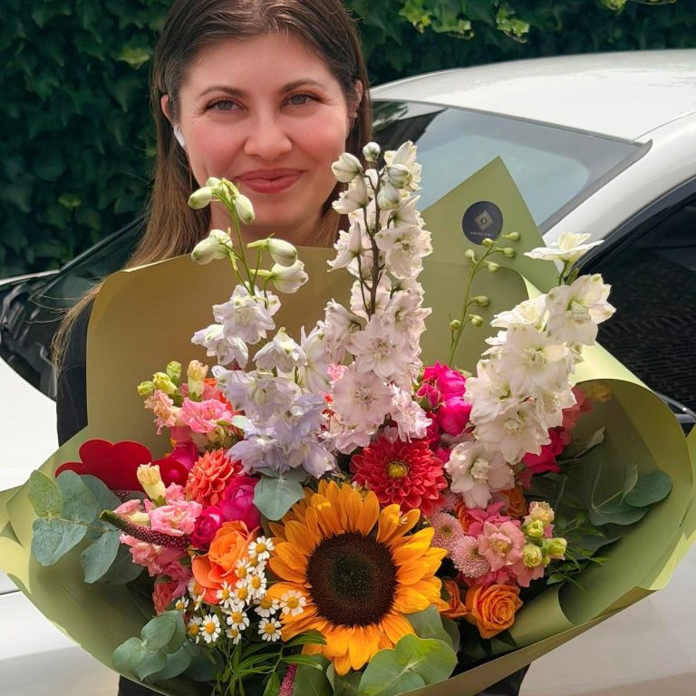 Ein üppiger Blumenstrauß mit Pfirsich- und weißen Rosen, Eukalyptus und zarten Akzenten.